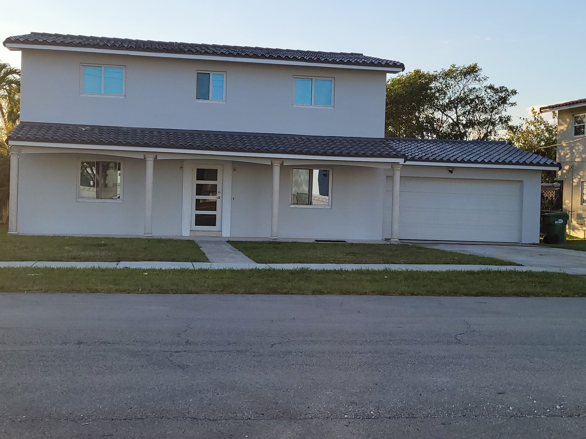 Modern white two-story home with garage in South Florida